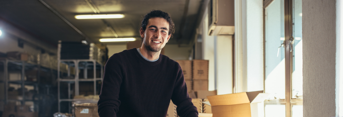 What Is GST Header man in warehouse smiling