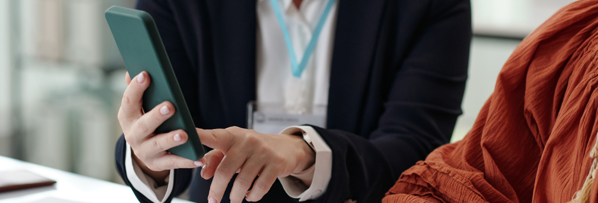 two people looking over an ipad