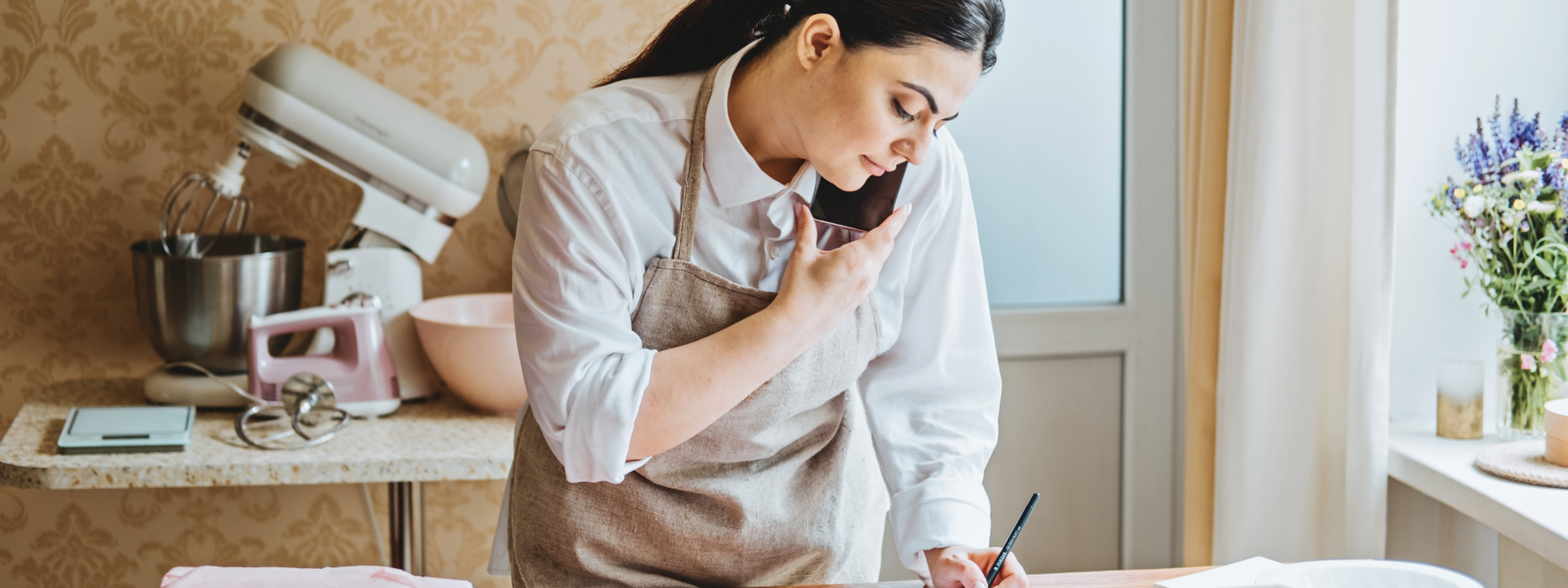Business owner on the phone and tapping on her tablet